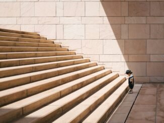 Kid facing the challenge of large stairs illustrating the diminishing returns that OpenAI is reportedly facing with the training and development of its latest AI model.