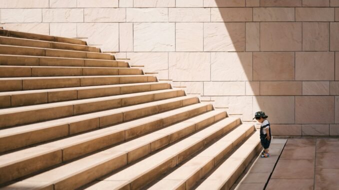 OpenAI faces diminishing returns with latest AI model Kid facing the challenge of large stairs illustrating the diminishing returns that OpenAI is reportedly facing with the training and development of its latest AI model.